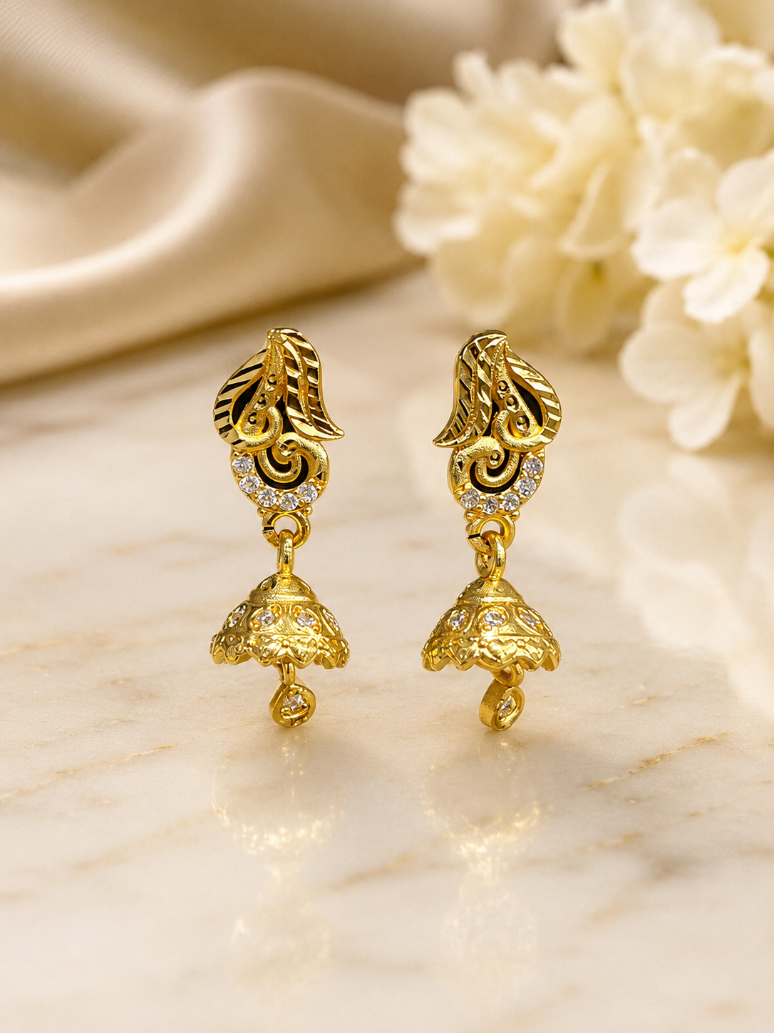 Elegant Gold-Plated Leaf Design Jhumka Earrings with Sparkling Stones
