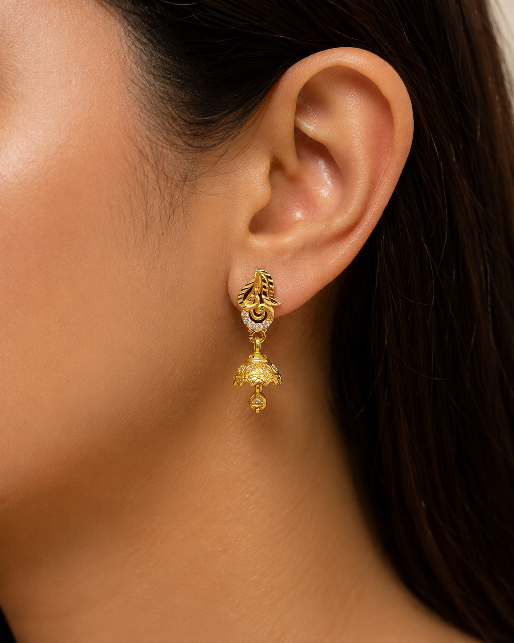 Elegant Gold-Plated Leaf Design Jhumka Earrings with Sparkling Stones